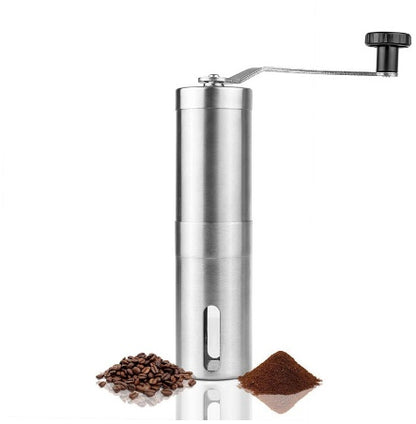 Stainless steel hand coffee grinder beside roasted coffee beans