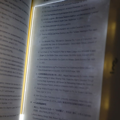 Dimmable LED reading lamp illuminating an open book for comfortable night reading