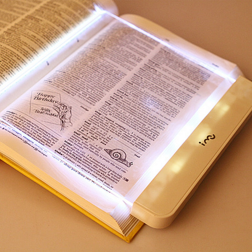 Dimmable LED reading lamp illuminating an open book for comfortable night reading