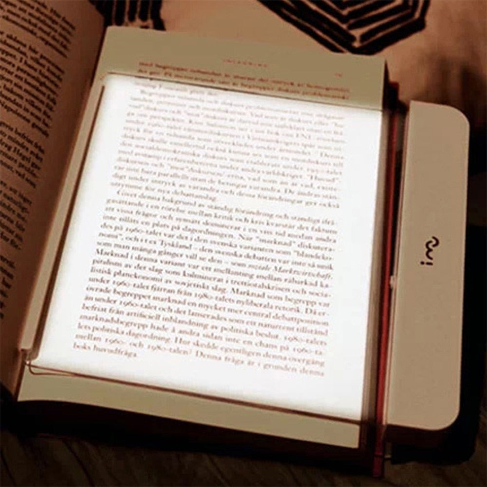 Dimmable LED reading lamp illuminating an open book for comfortable night reading