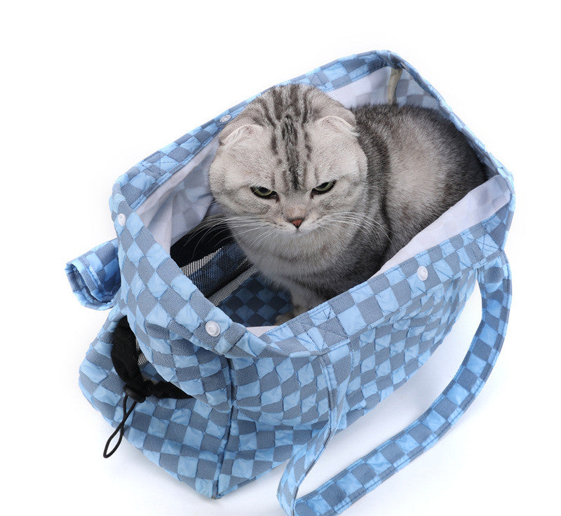 Cat resting inside portable cat carrier bag during travel