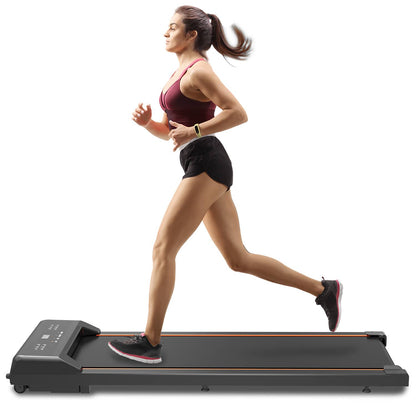 Under desk treadmill in use under office desk