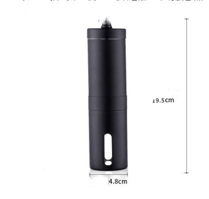 Stainless steel hand coffee grinder beside roasted coffee beans