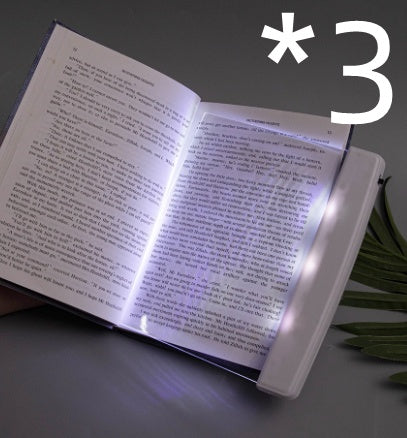 Dimmable LED reading lamp illuminating an open book for comfortable night reading