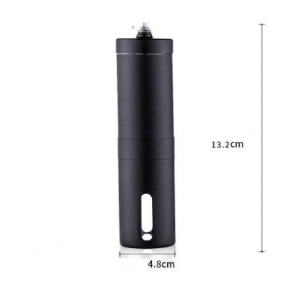 Stainless steel hand coffee grinder beside roasted coffee beans