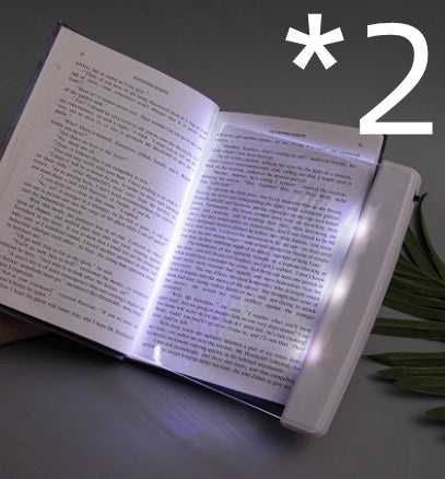 Dimmable LED reading lamp illuminating an open book for comfortable night reading