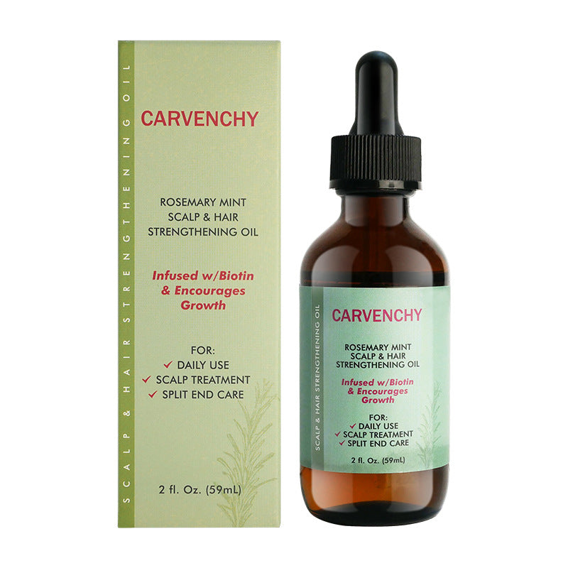 Rosemary hair care oil bottle beside beauty accessories indoors